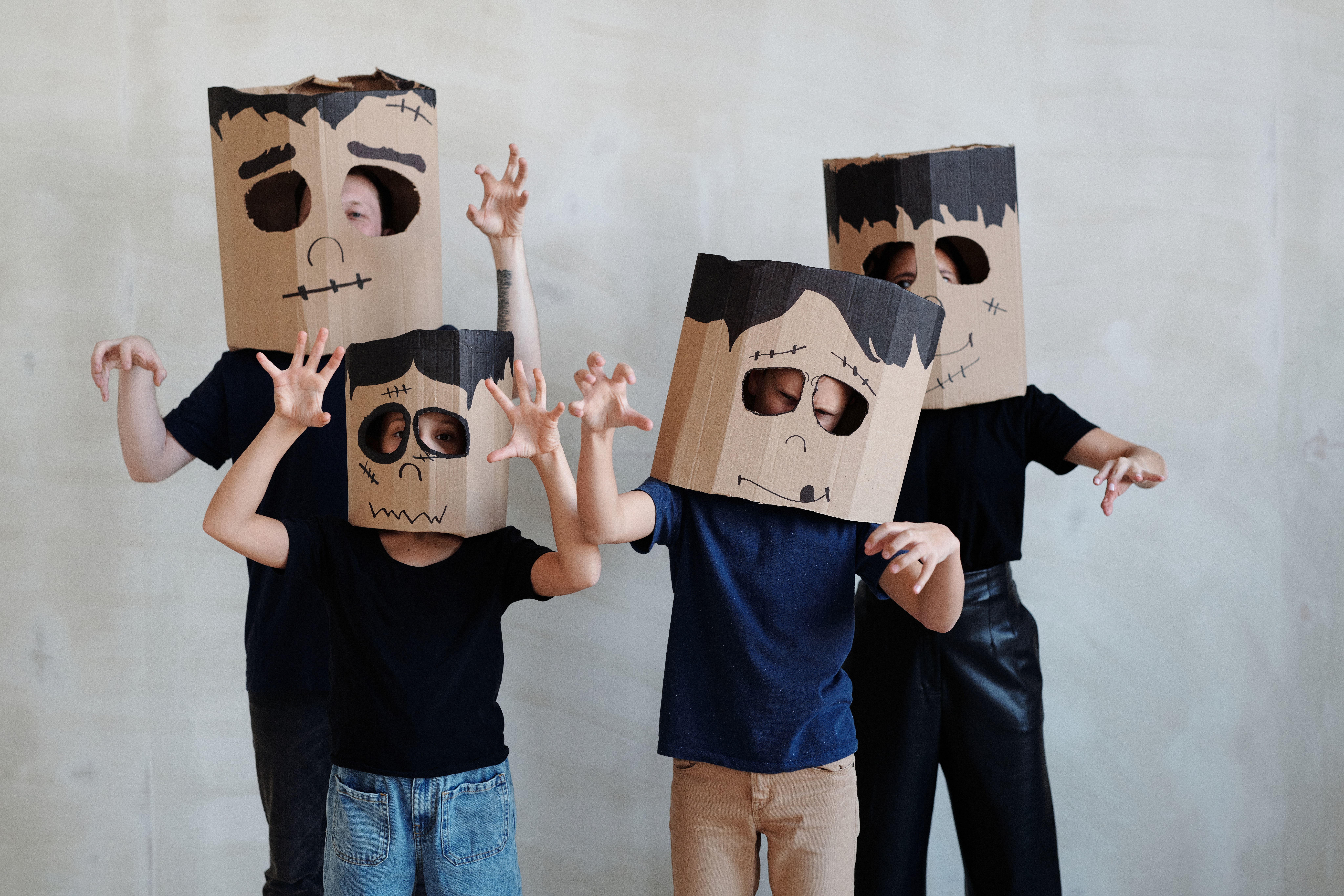Photo of a family wearing home made Halloween masks made from cardboard boxes.