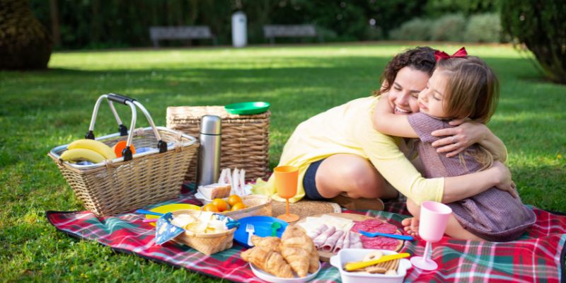 Little children hugging at a picnic